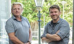 Jaap van Eck en Rard Rijcken staan in een deuropening naast elkaar met op de achtergrond een ouderwetse lantaarnpaal
