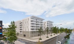 Impressie van de zijkant van het project Bouma Estate in het Europapark in Groningen een wit met lichtgrijs appartementencomplex van zes verdiepingen