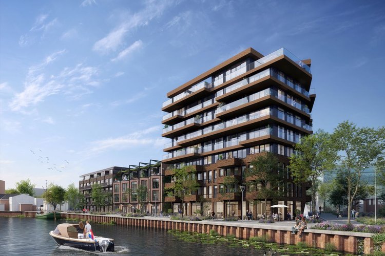 Een gebouw van 9 verdiepingen met lagere gebouwen eraan vast. Op de voorgrond is een kanaal.